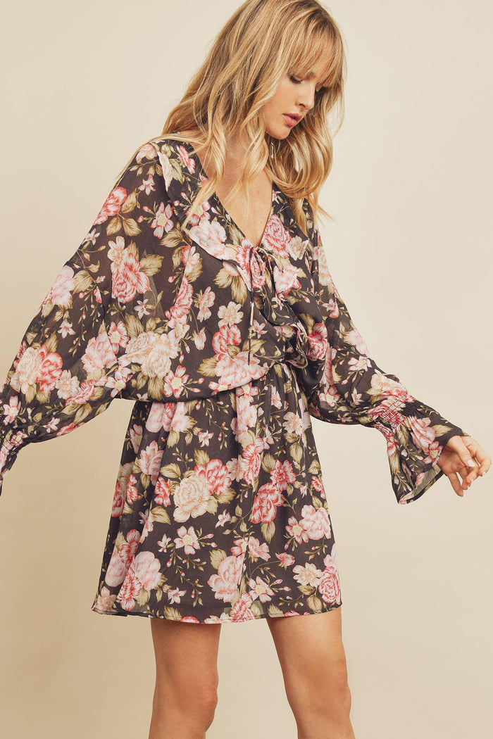 Woman wearing a floral dress against a beige background