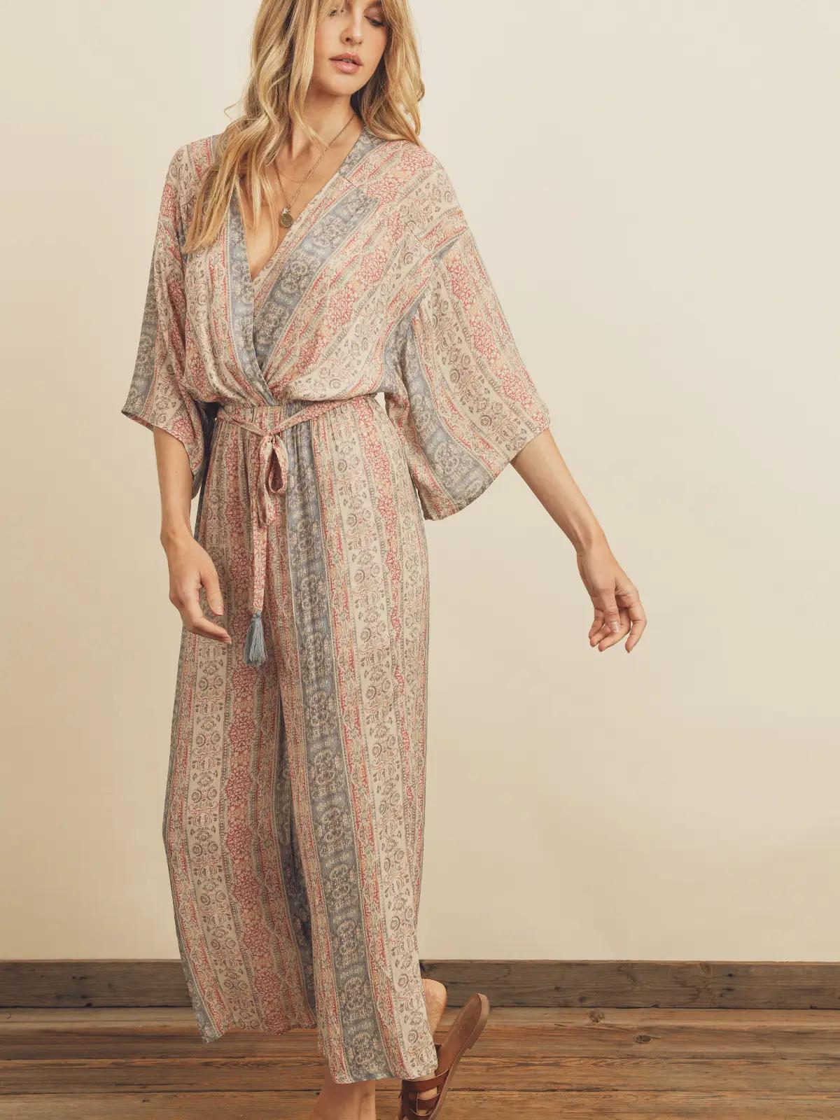 Woman wearing a patterned kimono-style dress against a plain background