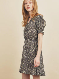 Woman wearing a floral dress against a beige background
