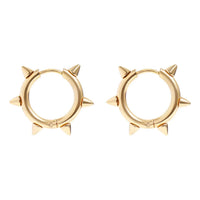 Gold hoop earrings with spike details on a white background