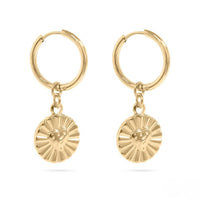 Gold hoop earrings with round disc charms on a white background