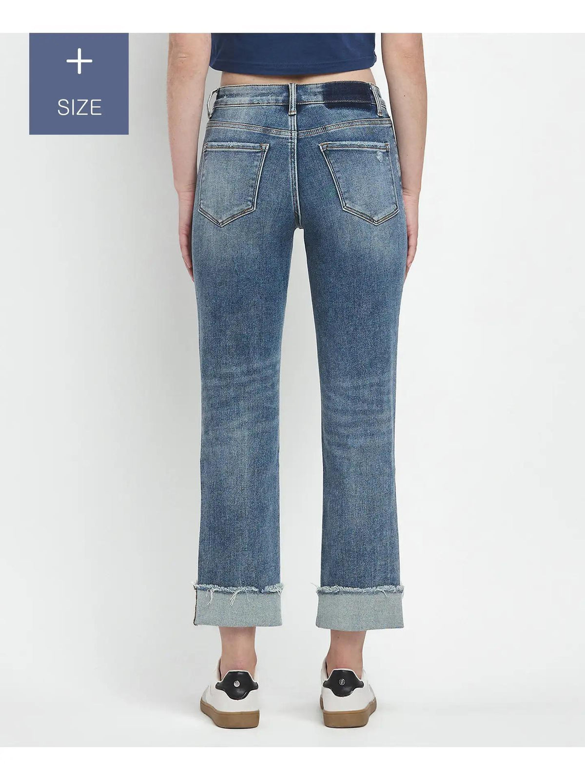 Blue jeans worn by a person on a white background