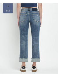 Blue jeans worn by a person on a white background