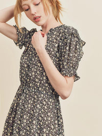 Woman wearing a floral dress against a beige background