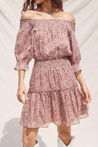 Pink floral off-shoulder dress on a plain background