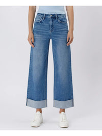 Person wearing blue wide-leg jeans on a light gray background