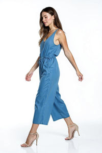 Woman wearing a blue jumpsuit on a white background