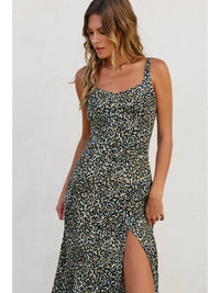 Woman wearing a leopard print dress with a white background