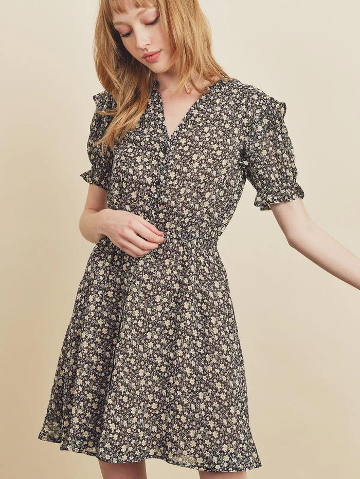 Woman wearing a floral dress against a beige background