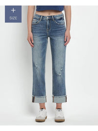 Person wearing blue jeans with a white background