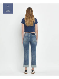 Person wearing blue jeans and a dark blue top on a white background