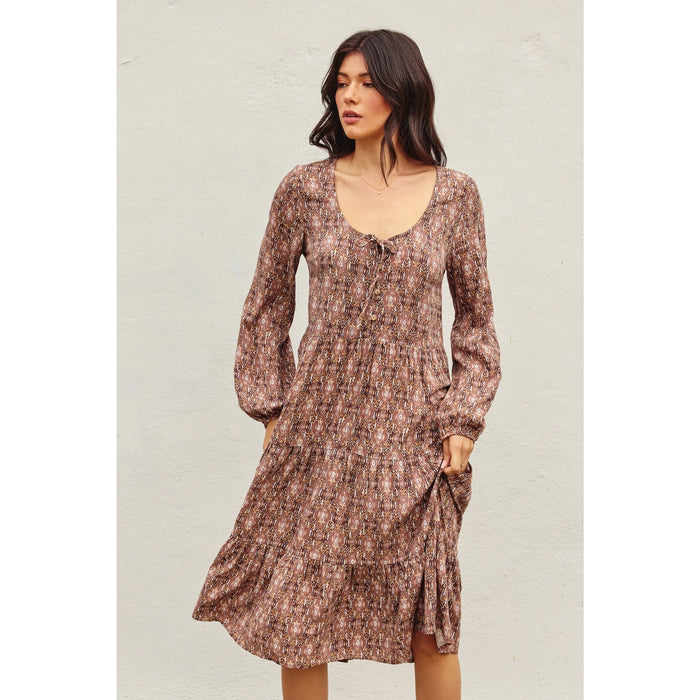 Model wearing Dress Forum Golden Sun Tiered Midi Dress in floral ethnic print with tie neckline and long sleeves